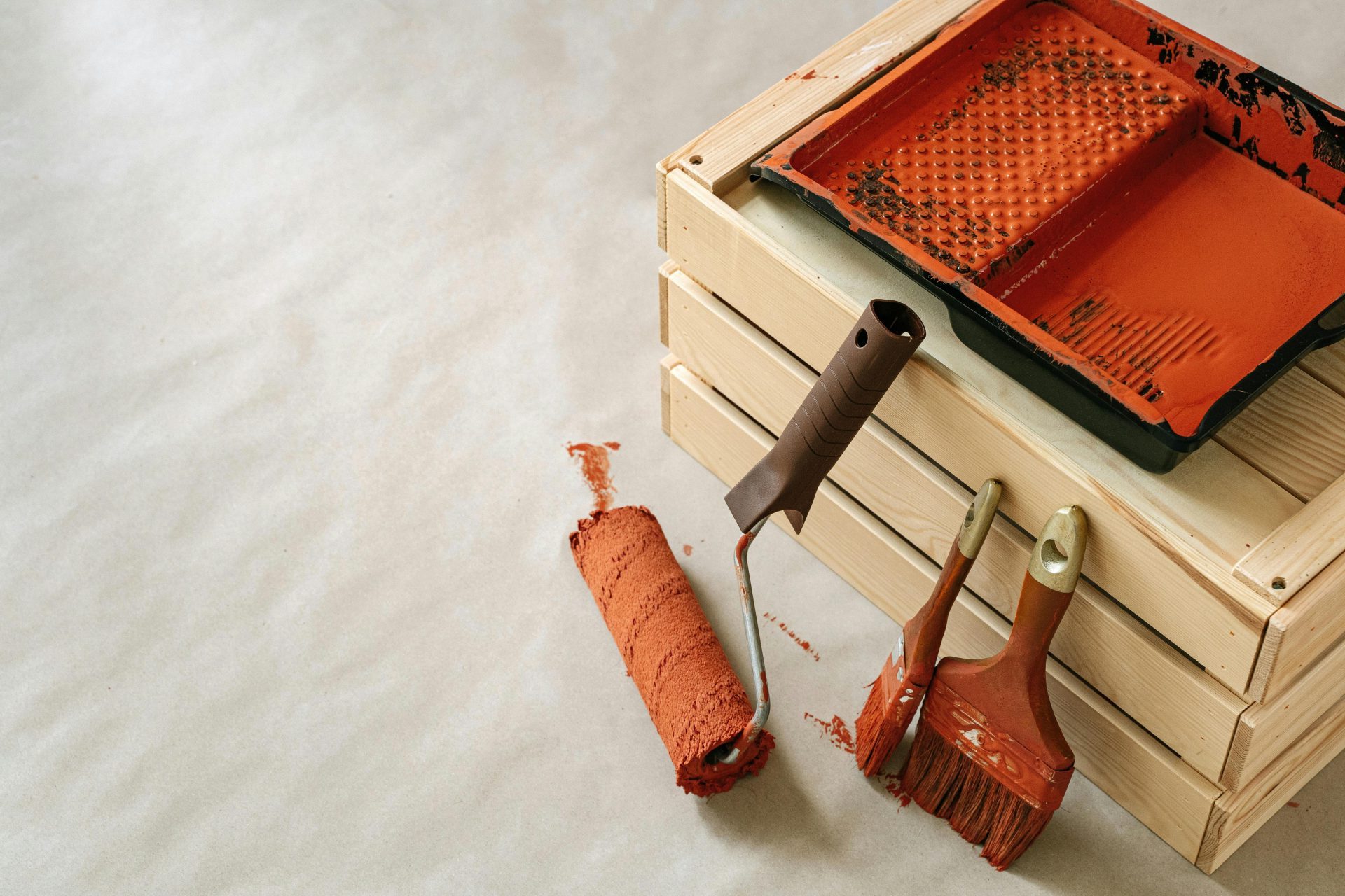 Un assortiment d'outils et de fournitures de peinture pour les projets de rénovation domiciliaire, comprenant des pinceaux et un rouleau.